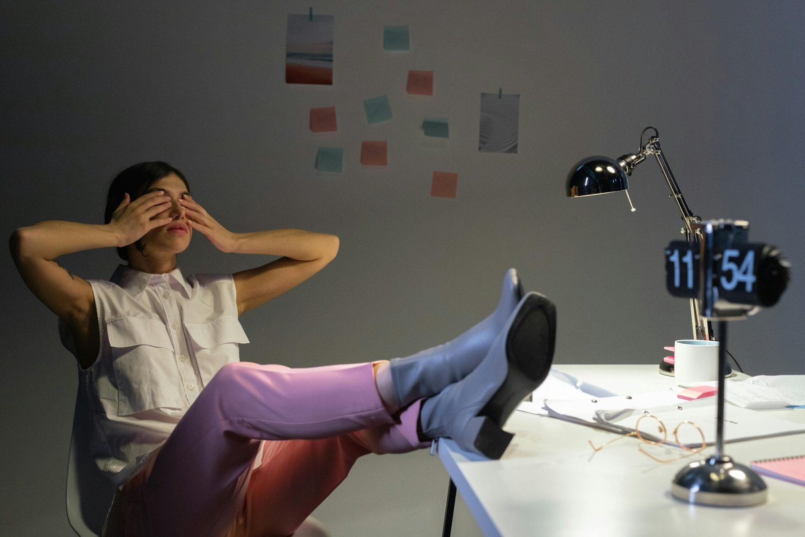 Overworked woman takes a break at her desk, showing exhaustion and relaxation